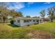 Exterior view of the home showing well-maintained landscaping, and a classic design at 2465 Thornhill Rd, Auburndale, FL 33823