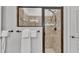 Modern bathroom showcasing a tiled glass shower and a towel rack with folded towels at 2726 Greyhawk Estates Ln, Lakeland, FL 33812