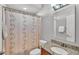 Bathroom featuring a vanity, sink, granite countertop, toilet, and a shower with a curtain at 2726 Greyhawk Estates Ln, Lakeland, FL 33812