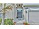 Close-up of the front entrance with a stylish door, manicured plants, and elegant lighting at 2726 Greyhawk Estates Ln, Lakeland, FL 33812