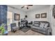 Well-lit home office with a desk, two monitors, a chair, and a leather sofa at 2726 Greyhawk Estates Ln, Lakeland, FL 33812