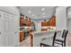 Modern kitchen featuring stainless steel appliances, granite countertops, and dark wood cabinets at 2726 Greyhawk Estates Ln, Lakeland, FL 33812