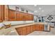 Spacious kitchen features granite counters, wood cabinets, and a stainless steel dishwasher at 2726 Greyhawk Estates Ln, Lakeland, FL 33812