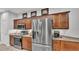 Spacious kitchen featuring stainless steel appliances, granite countertops, and dark wood cabinets at 2726 Greyhawk Estates Ln, Lakeland, FL 33812