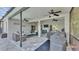 Expansive screened-in patio with ceiling fans, TV, hot tub and grilling area at 2726 Greyhawk Estates Ln, Lakeland, FL 33812