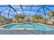 Backyard swimming pool with waterfall feature, surrounded by lush landscaping at 2726 Greyhawk Estates Ln, Lakeland, FL 33812