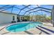 Beautiful screened-in pool with an outdoor seating area and lush landscaping, perfect for relaxation and entertaining at 2726 Greyhawk Estates Ln, Lakeland, FL 33812