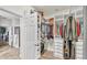 Organized walk-in closet featuring custom shelves, hanging rods, drawers, and a wood floor at 2726 Greyhawk Estates Ln, Lakeland, FL 33812