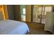 Neutral bedroom with a large bed, doorway into a sunroom, and view to another room at 29 Buck Cir, Haines City, FL 33844