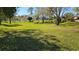 Green common ground featuring mature shade trees and a walking path at 29 Buck Cir, Haines City, FL 33844