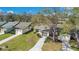 Aerial view of the home featuring an attached garage and a well manicured lawn at 29 Buck Cir, Haines City, FL 33844