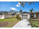 Inviting single-story home featuring a clean driveway, attached garage, and tidy front yard at 29 Buck Cir, Haines City, FL 33844