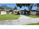 Charming single-story home featuring a well-manicured lawn and a spacious driveway at 29 Buck Cir, Haines City, FL 33844