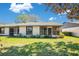 The back of the home features a screened in porch and simple landscaping at 29 Buck Cir, Haines City, FL 33844