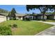Charming single story home boasting a lush green lawn and meticulously maintained landscaping at 29 Buck Cir, Haines City, FL 33844