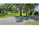 Scenic view of a well-maintained community green space with mature trees and walking paths at 29 Buck Cir, Haines City, FL 33844