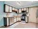 Bright kitchen featuring white cabinets with dark trim, stainless steel appliances, and tile floors at 29 Buck Cir, Haines City, FL 33844