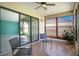 Enclosed sunroom featuring sliding glass doors, a ceiling fan, and window coverings at 29 Buck Cir, Haines City, FL 33844