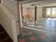 Unfinished basement with decorative tile floor and stone accents around support beams and french doors at 330 Callitris Ave, Polk City, FL 33868