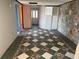 Unfinished basement hallway featuring tile flooring with stone accent wall and doorway view at 330 Callitris Ave, Polk City, FL 33868