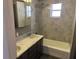 Bathroom featuring double sinks and a shower and tub combo at 330 Callitris Ave, Polk City, FL 33868