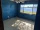 Bedroom featuring blue walls, a ceiling fan, and a window with a waterfront view at 330 Callitris Ave, Polk City, FL 33868