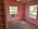 Pink bedroom featuring carpet and a window AC unit at 330 Callitris Ave, Polk City, FL 33868