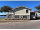 Exterior view of a two-story home with stone accents and a red roof at 330 Callitris Ave, Polk City, FL 33868