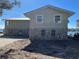 Side exterior of a two-story home with siding and stone foundation at 330 Callitris Ave, Polk City, FL 33868