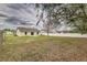 Large backyard with mature trees and a privacy fence, perfect for outdoor activities at 3815 Horizon View Loop, Lakeland, FL 33813