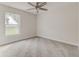 Cozy bedroom with plush carpeting, a ceiling fan, and a window view at 3815 Horizon View Loop, Lakeland, FL 33813