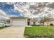 Inviting home exterior with a two car garage, well-kept lawn, and beautiful blue sky at 3815 Horizon View Loop, Lakeland, FL 33813