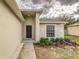 Charming front entrance with a dark door, surrounded by well-maintained landscaping at 3815 Horizon View Loop, Lakeland, FL 33813