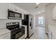 Well-equipped kitchen with stainless steel appliances, white cabinets, and tiled backsplash at 3815 Horizon View Loop, Lakeland, FL 33813