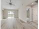 Bright living room with modern flooring, ceiling fan, and sliding glass doors to the backyard at 3815 Horizon View Loop, Lakeland, FL 33813