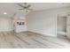 Bright, open living room featuring wood-look floors, neutral walls, and ceiling fan at 3815 Horizon View Loop, Lakeland, FL 33813