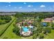 Expansive aerial perspective showcasing the property's pool, clubhouse, and well-manicured green spaces within a residential community at 3965 Aquilla Dr, Lakeland, FL 33810