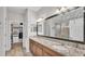 This stylish bathroom boasts a double sink vanity, a large mirror, and a walk-in closet at 3965 Aquilla Dr, Lakeland, FL 33810