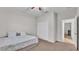 Neutral bedroom with a closet, ceiling fan and an open doorway to the ensuite bath at 3965 Aquilla Dr, Lakeland, FL 33810