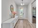 This elegant foyer features wood-look tile flooring, a modern light, and a decorative vase at 3965 Aquilla Dr, Lakeland, FL 33810