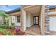 A front porch entrance that features stone columns, manicured bushes, and brick pavers at 3965 Aquilla Dr, Lakeland, FL 33810