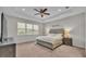 This beautiful main bedroom features a tray ceiling, a ceiling fan, and a large window at 3965 Aquilla Dr, Lakeland, FL 33810