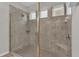 This stylish shower has a built-in bench, a tiled floor, and a glass door at 3965 Aquilla Dr, Lakeland, FL 33810