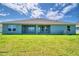 View of backyard with a lawn, patio, and home's facade at 4058 Tullamore Ln, Auburndale, FL 33823