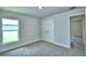 Bedroom featuring plush carpet, neutral walls, closet, and a bright window at 4058 Tullamore Ln, Auburndale, FL 33823