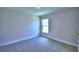 Bedroom featuring plush carpet, neutral walls, and a bright window at 4058 Tullamore Ln, Auburndale, FL 33823