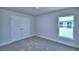 Bright bedroom with carpet, double door closet, and a view from the window at 4058 Tullamore Ln, Auburndale, FL 33823