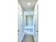 Hallway leading to the bathroom with white doors at 4058 Tullamore Ln, Auburndale, FL 33823