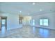 Expansive living area with ceramic tile flooring, natural light, and seamless open space at 4058 Tullamore Ln, Auburndale, FL 33823