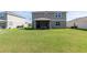 Home's green backyard featuring healthy turf and a partially screened lanai at 4525 Breccia Ln, Lakeland, FL 33811